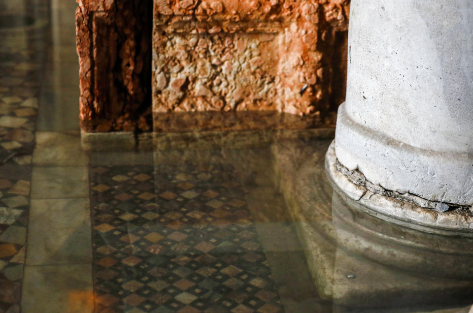 FILE — Seawater floods the floors of St. Mark's Basilica in Venice, northern Italy in this Tuesday, Dec. 17, 2019, file photo. Seawaters no longer endanger the marble mosaics of the floor after glass barriers that prevent seawater from flooding inside during high tide have been recently installed around the 900-year-old basilica. St. Mark's Square is the lowest-laying city area and frequently ends up underwater during extreme weather.(AP Photo/Antonio Calanni)