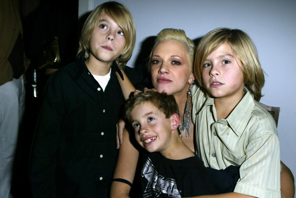 Asia Argento poses with a 7-year-old Jimmy Bennett, center, and co-stars Cole and Dylan Sprouse at a 2003 wrap party for their film, <i>The Heart Is Deceitful Above All Things</i>. (Photo: Jeff Vespa/WireImage)