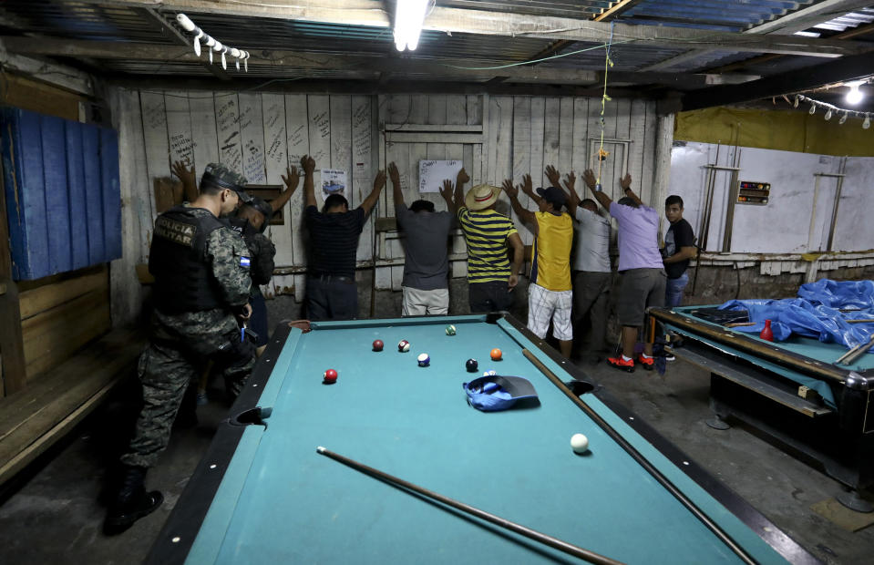 In this Aug. 21, 2019 photo, soldiers enter a pool hall during their routine patrol in Tegucigalpa, Honduras. Ironically, the extradition of drug capos to the U.S. under Honduran President Juan Orlando Hernández could have helped build the case against his own brother, in which he is now implicated. (AP Photo/Eduardo Verdugo)