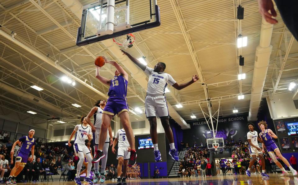 February 3, 2023; Goodyear, Ariz; USA; Notre Dame Prep forward Mitchell Perkins (13) goes up for a layup against Millennium foward Donovan Franks (15) during a game at Millennium High School.