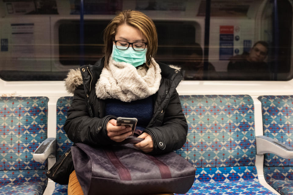 A woman wearing a facemark on the London Underground. PA Photo. Picture date: Wednesday February 26, 2020. See PA story HEALTH Coronavirus. Photo credit should read: Ian Hinchliffe/PA Wire (Photo by Ian Hinchliffe/PA Images via Getty Images)