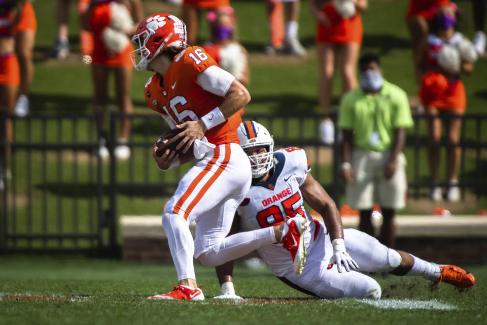 Clemson quarterback Trevor Lawrence (16) runs the ball during an NCAA college football game against Syracuse in Clemson, S.C., Saturday, Oct. 24, 2020. (Ken Ruinard/Pool Photo via AP)