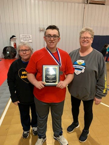 Madison High senior Chris Dockery showcases the Mountain Amateur Athletic Club plaque he was awarded in a May 2022 ceremony.