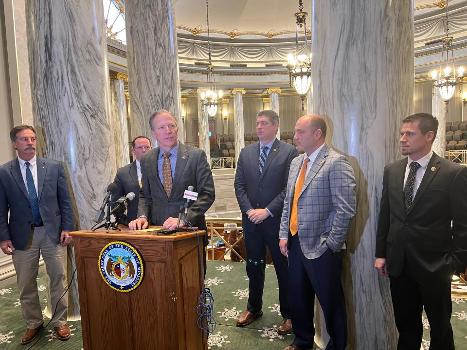 Members of the Senate Conservative Caucus (from left: Sens. Mike Moon, Eric Burlison, Bob Onder, Bill Eigel, Denny Hoskins, Andrew Koenig) speak to reporters in the Missouri Senate in Jefferson City on March 10, 2022.