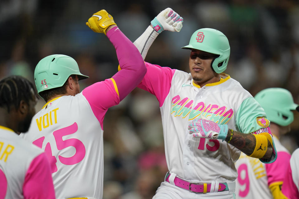 San Diego Padres' Manny Machado, right, celebrates with teammate Luke Voit after hitting a two-run home run during the fifth inning of a baseball game against the Minnesota Twins, Friday, July 29, 2022, in San Diego. (AP Photo/Gregory Bull)