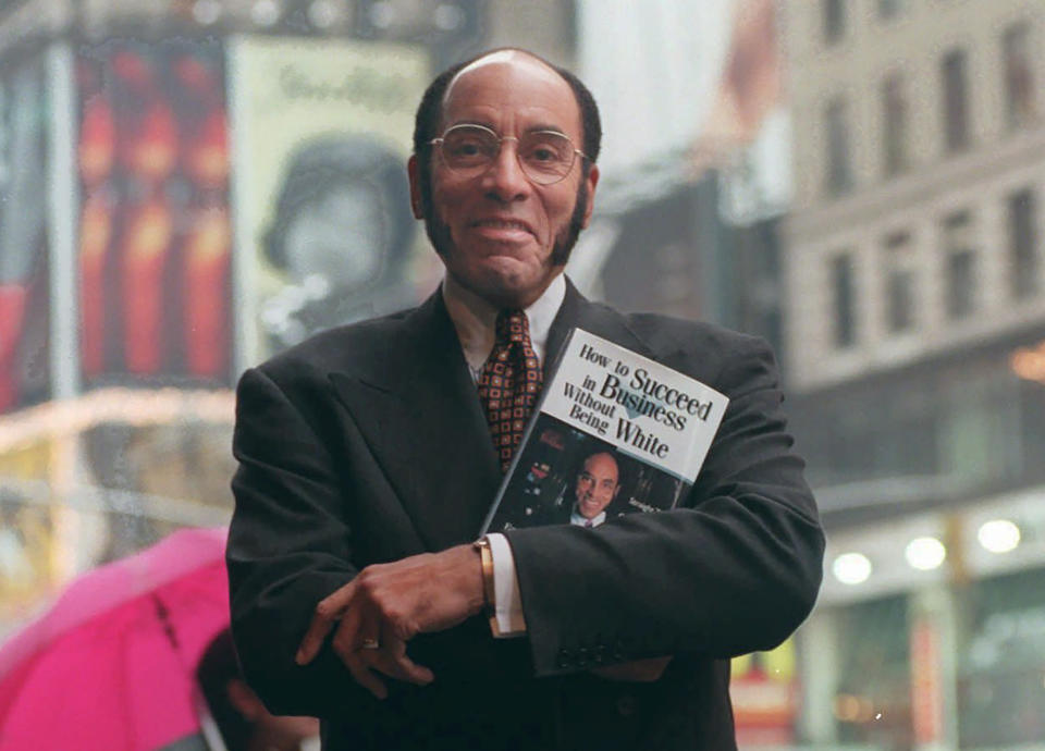 FILE - This Aug. 17, 1997 file photo shows Earl G. Graves Sr. with his book "How To Succeed In Business Without Being White" in New York. Graves Sr., who championed black businesses as the founder of the first African American-owned magazine focusing on black entrepreneurs, has died. He was 85. His son said Graves died Monday, April 6, 2020. (AP Photo/Bebeto Matthews, File)