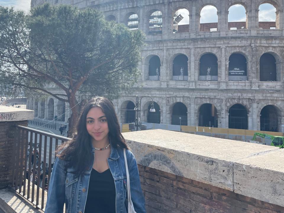 Mellak Abduelal standing in front of the colosseum in rome