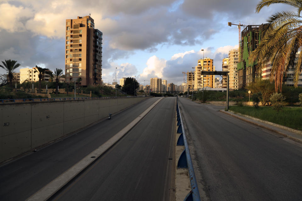 A highway is empty of cars during a lockdown aimed at curbing the spread of the coronavirus, in Beirut, Lebanon, Friday, Jan. 15, 2021. Lebanon's parliament has approved a draft law to allow the importing of vaccines into the tiny country to fight the spread of coronavirus. (AP Photo/Bilal Hussein)