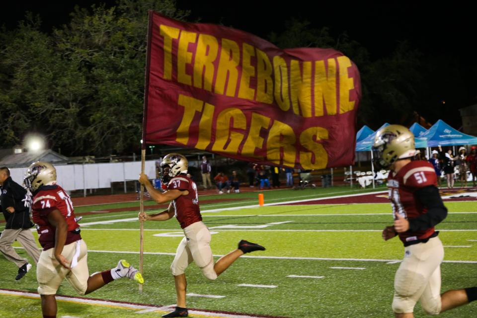 Terrebonne's Loukas Naquin (37) runs on the field with a flag during a game against Thibodaux in Houma on Oct. 29.