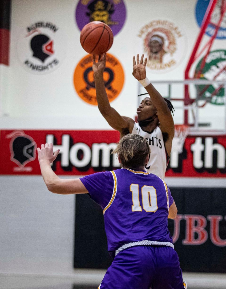 Auburn's Rob Chaney shoots the ball against Hononegah's Cole Warren (10) at Auburn High School on Friday, Jan. 21, 2022, in Rockford. Chaney scored a game-high 27 points to lead Auburn to a 77-69 victory.