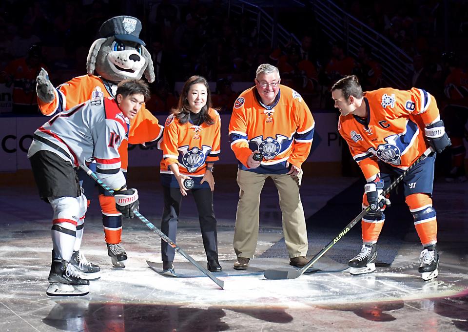 John Doucette and Grace Lee participate in the honorary puck-drop before the Railers battle Adirondack on Opening Night.