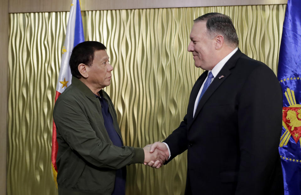 Philippine President Rodrigo Duterte, left, greets U.S. State Secretary Mike Pompeo upon arrival at Villamor Air Base in suburban Pasay city southeast of Manila, Philippines, Thursday, Feb. 28, 2019. Pompeo, who joined U.S. President Donald Trump in the second summit with North Korean leader Kim Jong-un in Vietnam, is here for talks on the two countries' relations as well as the mutual defense treaty. (AP Photo/Bullit Marquez, POOL)