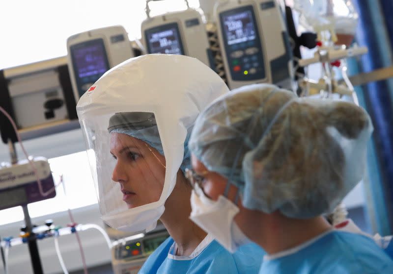 Members of the medical personnel work with a patient suffering from the coronavirus disease (COVID-19) at the intensive care unit at ZNA Stuivenberg hospital in Antwerp