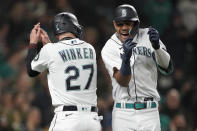 Seattle Mariners' Julio Rodriguez, right, celebrates with Jesse Winker (27) after hitting a two-run home run to score Winker against the Oakland Athletics during the fifth inning of a baseball game Tuesday, May 24, 2022, in Seattle. (AP Photo/Ted S. Warren)