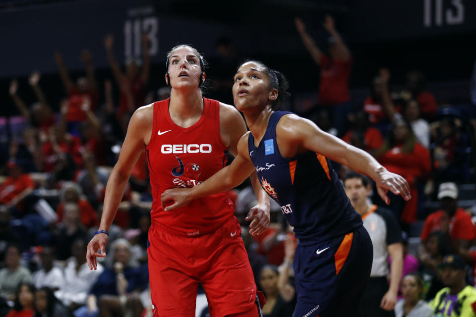 Washington Mystics forward Elena Delle Donne, left, and Connecticut Sun forward Alyssa Thomas watch a free throw attempt in the second half of Game 1 of basketball's WNBA Finals, Sunday, Sept. 29, 2019, in Washington. (AP Photo/Patrick Semansky)