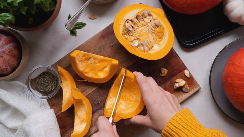 hands cutting pumpkins