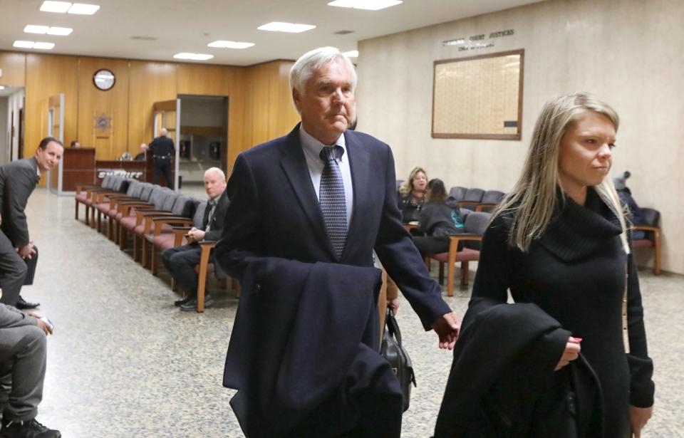 James Krauseneck walks into court, with daughter Sara, to face charges in the 1982 murder of his then-wife Cathleen, Friday, Nov. 8, 2019 at the Hall of Justice in Rochester. 