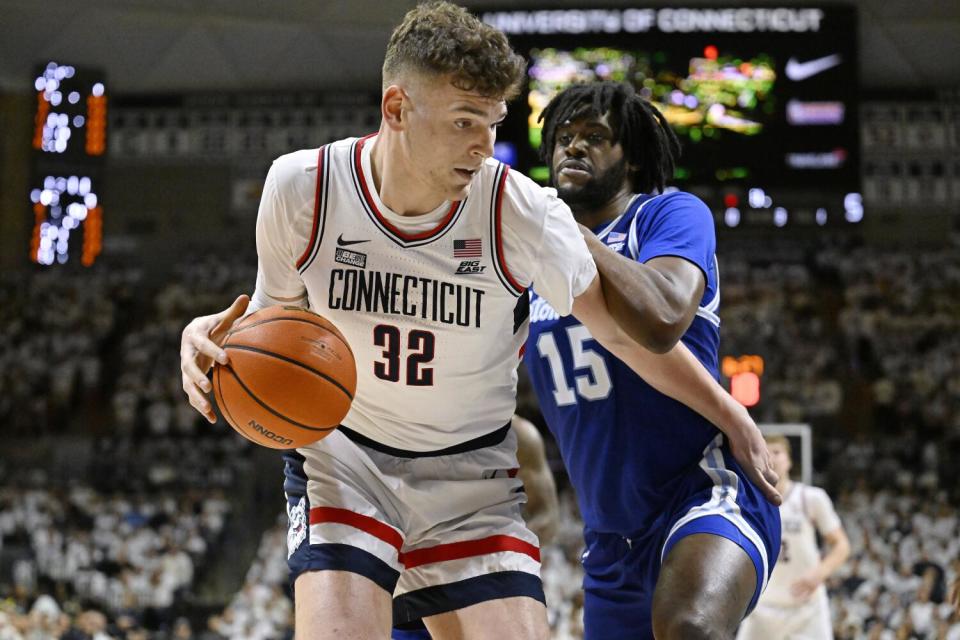 Connecticut center Donovan Clingan is guarded by Seton Hall center Jaden Bediako during a game on March 3.