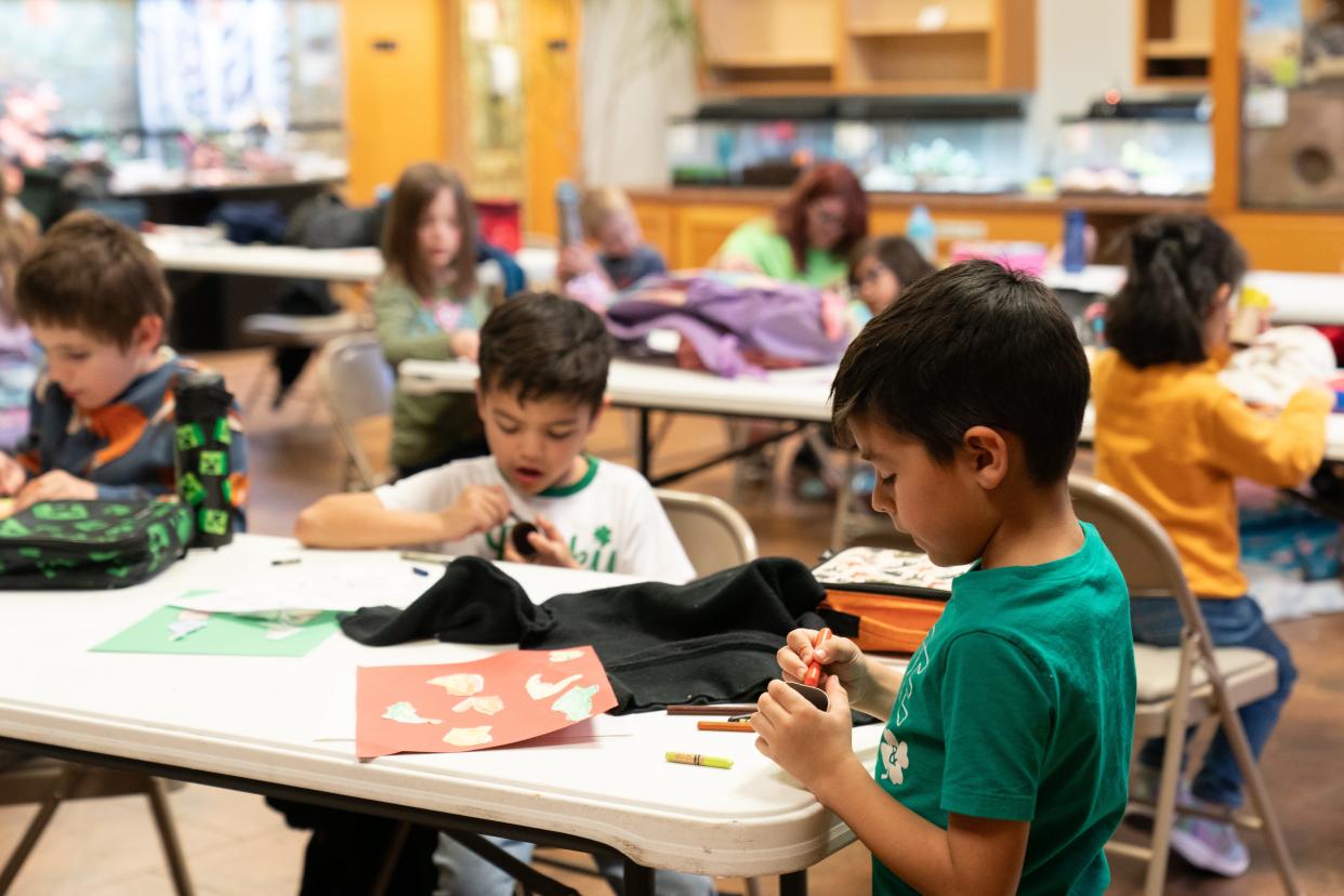 Children create rain sticks as part of an activity during a single-day camp at the Topeka Zoo. The zoo offers multiple camps throughout the year, including one more day camp on April 1 and a summer camp beginning the first week of June.