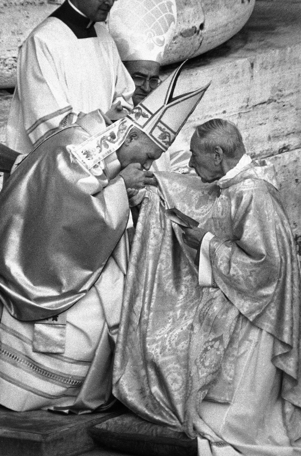 FILE - In this Oct. 22, 1978 file photo, Pope John Paul II kisses the hand of Polish Cardinal Stefan Wyszynski in Vatican City, when the successor of late Pope John Paul I was officially installed as the new Pontiff, and cardinals paid obedience to the Pope. Poland's top political leaders gathered in a Warsaw church Sunday, Sept. 12, 2021 for the beatification of two revered figures of the Catholic church — a cardinal who led the Polish church's resistance to communism and a blind nun who devoted her life to helping others who couldn't see. (AP Photo, File)