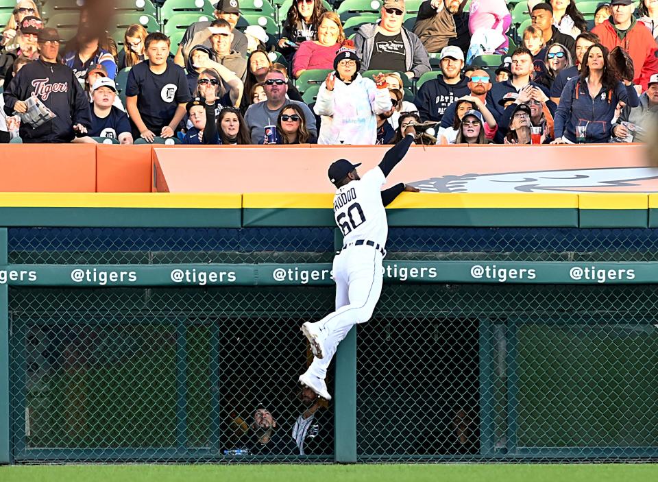 Detroit Tigers outfielder Akil Baddoo (60) steals a home run from Kansas City Royals right fielder Hunter Dozier in the second inning in Detroit, at Comerica Park on Saturday, Sept. 25, 2021.