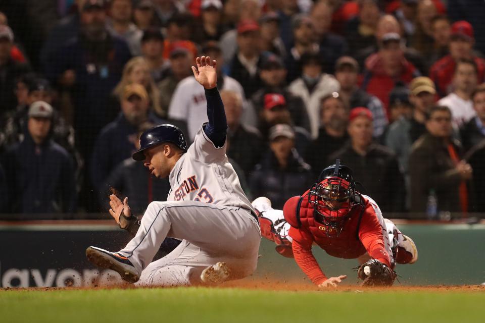 Michael Brantley slides safely to score a run in the ninth inning of Game 4.