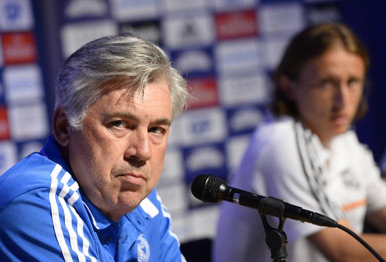 Real Madrid's coach Carlo Ancelotti (L) was accused by Croatia's national team doctor for Luka Modric's (R) latest injury problems