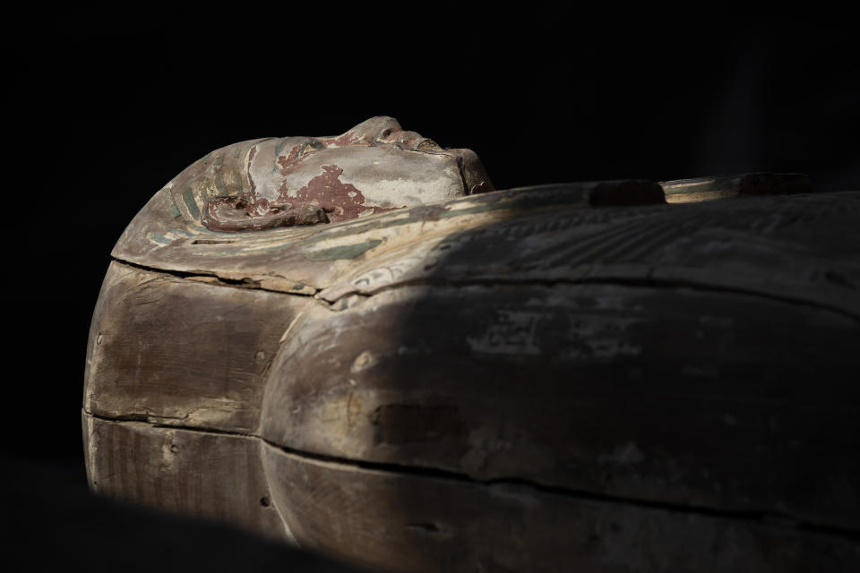 A sarcophagus that is around 2500 years old is shown at the Saqqara archaeological site, 30 kilometers (19 miles) south of Cairo, Egypt, Saturday, Oct. 3, 2020. Egypt says archaeologists have unearthed about 60 ancient coffins in a vast necropolis south of Cairo. The Egyptian Tourism and Antiquities Minister says at least 59 sealed sarcophagi with mummies inside were found that had been buried in three wells more than 2,600 years ago. (AP Photo/Mahmoud Khaled)