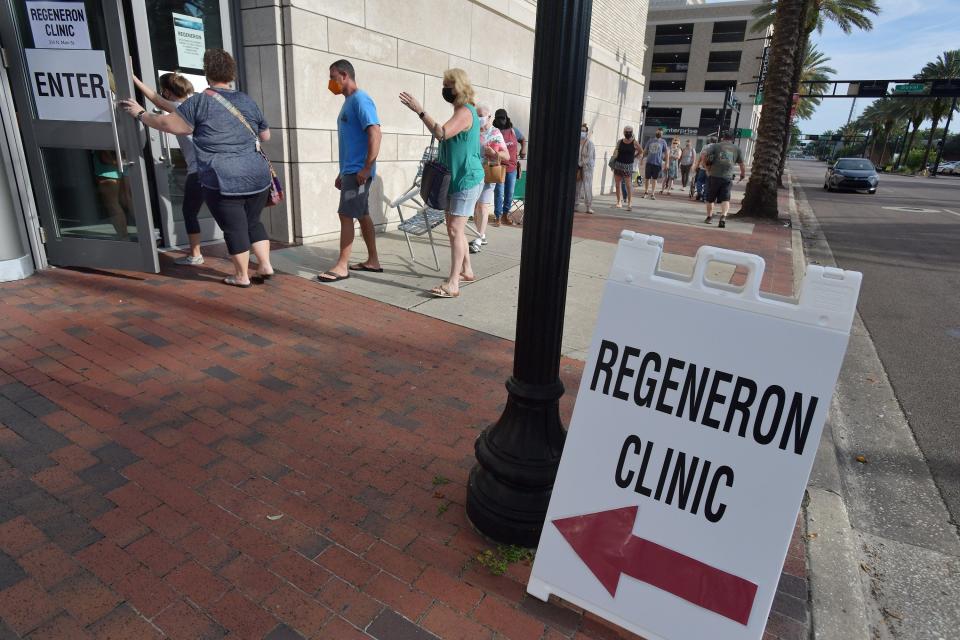 Residents make their way down the sidewalk outside the main library after the doors to the Regeneron clinic opened Friday morning. About 50 people were in line outside the downtown Jacksonville, Florida main library Friday, August 20, 2021, as they waited for the 9 am opening of the clinic inside that gives Regeneron's Monoclonal Antibody treatment to mitigate the symptoms of COVID-19.