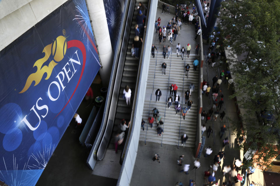 FILE - In this Sept. 3, 2017, file photo, tennis fans move in and out of Arthur Ashe Stadium during the fourth round of the U.S. Open tennis tournament in New York. How much does each first-round loser in singles at the U.S. Open take home in prize money? Who holds the women's record for most aces in the tournament? See how much you know about the year's last Grand Slam tennis tournament by taking the AP's U.S. Open quiz. (AP Photo/Frank Franklin II, File)