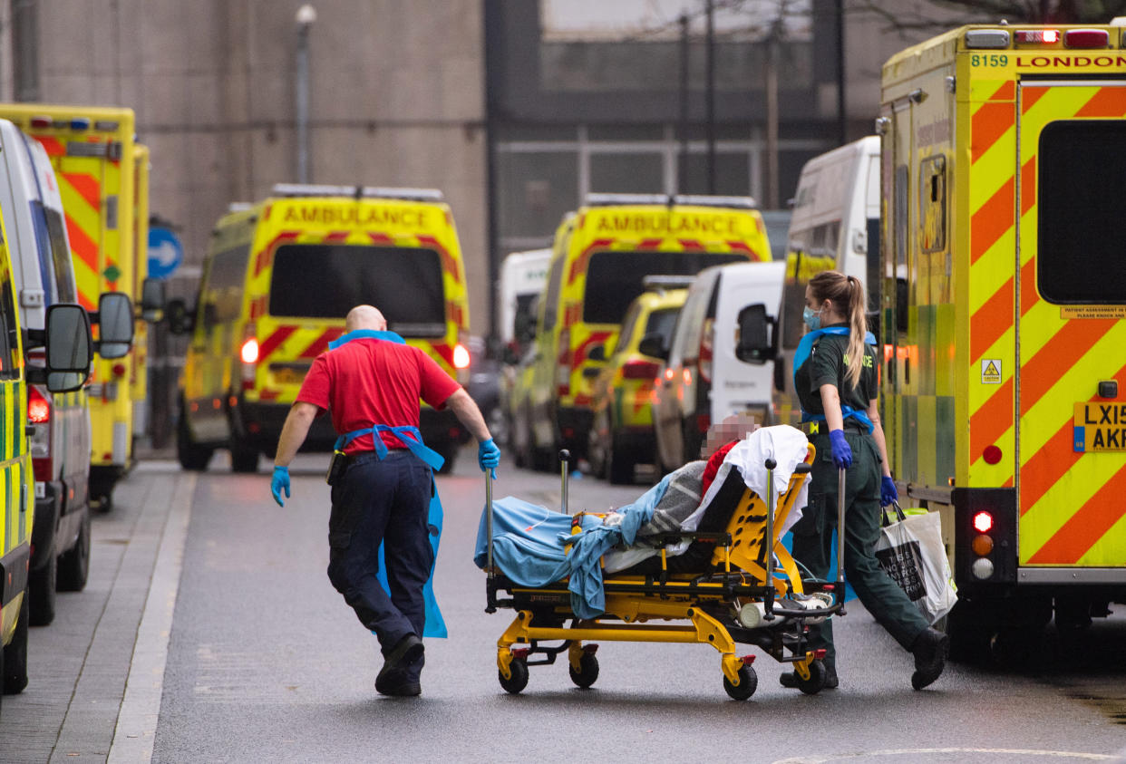 IMAGE PIXELLATED BY PA PICTURE DESK Paramedics unload a patient from an ambulance outside the Royal London Hospital in London. (Photo by Dominic Lipinski/PA Images via Getty Images)