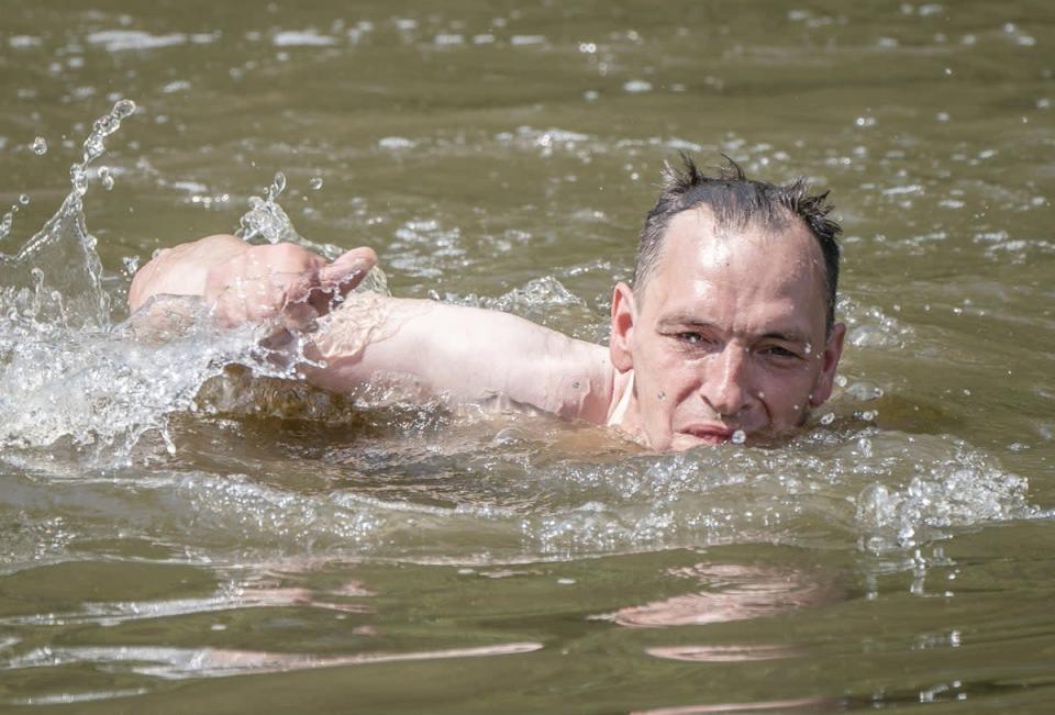 A man swims in a lake in Sandall Park, Doncaster (Danny Lawson/PA) (PA Wire)
