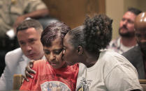 Deborah Marion, left, mother of slain Grizzlies player Lorenzen Wright, is comforted during a hearing in Judge Lee Coffee's court in Memphis, Tenn., on Thursday, July 25, 2019 where Sherra Wright plead guilty to the first degree murder of Lorenzen Wright. (Jim Weber/Daily Memphian via AP)