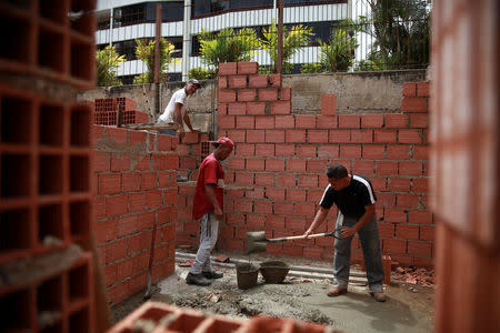 Construction workers are seen working in a new infrastructure at an expropriated golf field of the Caraballeda Golf & Yacht Club in Caraballeda, Venezuela February 20, 2018. Picture taken February 20, 2018. REUTERS/Adriana Loureiro