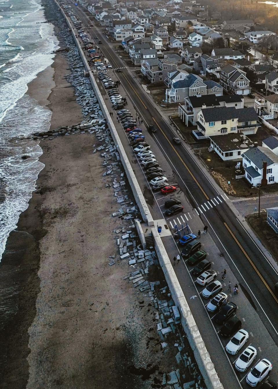 A large group of car enthusiasts gather at the North Beach seawall at Hampton Beach Saturday, April 1, 2023. Police increased their presence as well, due to concerns about rowdy behavior in the past.