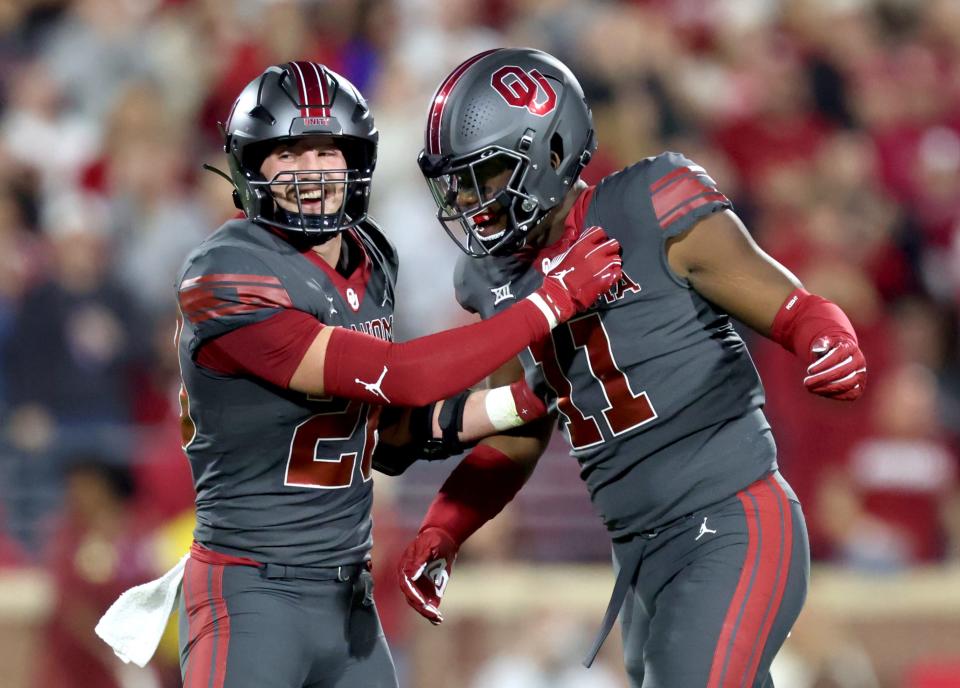 OU's Danny Stutsman, left, and Kobie McKinzie celebrate in the first half of Saturday's game against West Virginia at Gaylord Family-Oklahoma Memorial Stadium in Norman.