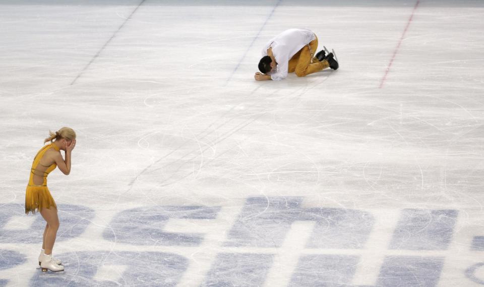 Tatiana Volosozhar and Maxim Trankov of Russia react after finishing their routine in the pairs free skate figure skating competition at the 2014 Winter Olympics, Wednesday, Feb. 12, 2014, in Sochi, Russia. (AP Photo/Bernat Armangue)