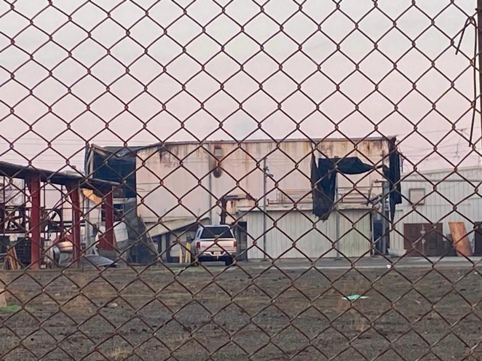 A charred building could been seen from the street after crews fought a fire inside a large industrial building in Fresno south of downtown on Wednesday, Nov. 8, 2022, according to Fresno Fire Department. THADDEUS MILLER/tmiller@fresnobee.com