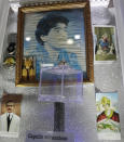 A lock of hair claimed to be from soccer legend and former Napoli player Diego Armando Maradona is displayed on a makeshift shrine dedicated to him inside the Coffee Bar Nilo in downtown Naples, Italy, Wednesday, Sept. 18, 2019. The altar inside Bar Nilo features a strand of Maradona’s hair inside a rotating, transparent box. It’s labeled “miraculous hair.” (AP Photo/Gregorio Borgia)