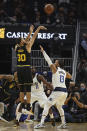 Golden State Warriors guard Stephen Curry (30) shoots over Dallas Mavericks guard Jalen Brunson (13) during the first half of an NBA basketball game in San Francisco, Tuesday, Jan. 25, 2022. (AP Photo/Jed Jacobsohn)