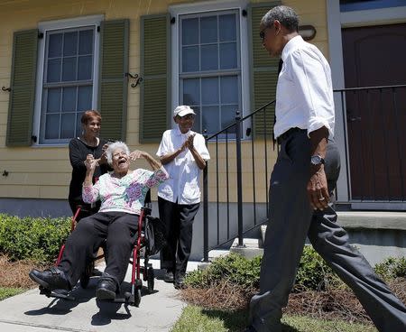 U.S. President Barack Obama is welcomed by local residents to an area rebuilt after Hurricane Katrina during a presidential visit to New Orleans, Louisiana, August 27, 2015. REUTERS/Carlos Barria