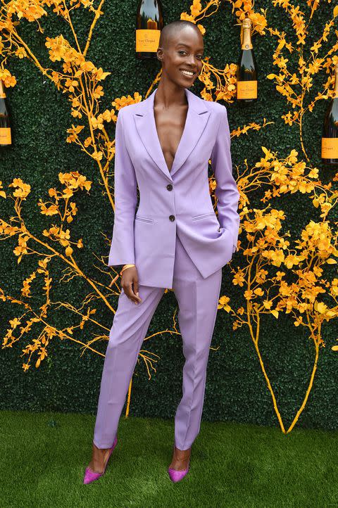 <p>Wearing a lilac suit with cerise pumps.</p>