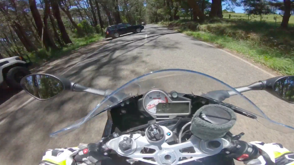 The motorcyclist spots a car performing a u-turn as they approach on a road in Kinglake. Source: Reddit/ beanie-io