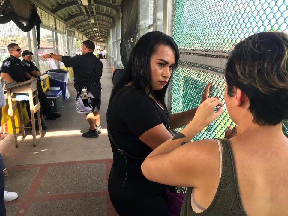 Mayela Villegas consults with Dani Marrero Hi, a fellow at the Texas Civil Rights Project, on a border bridge