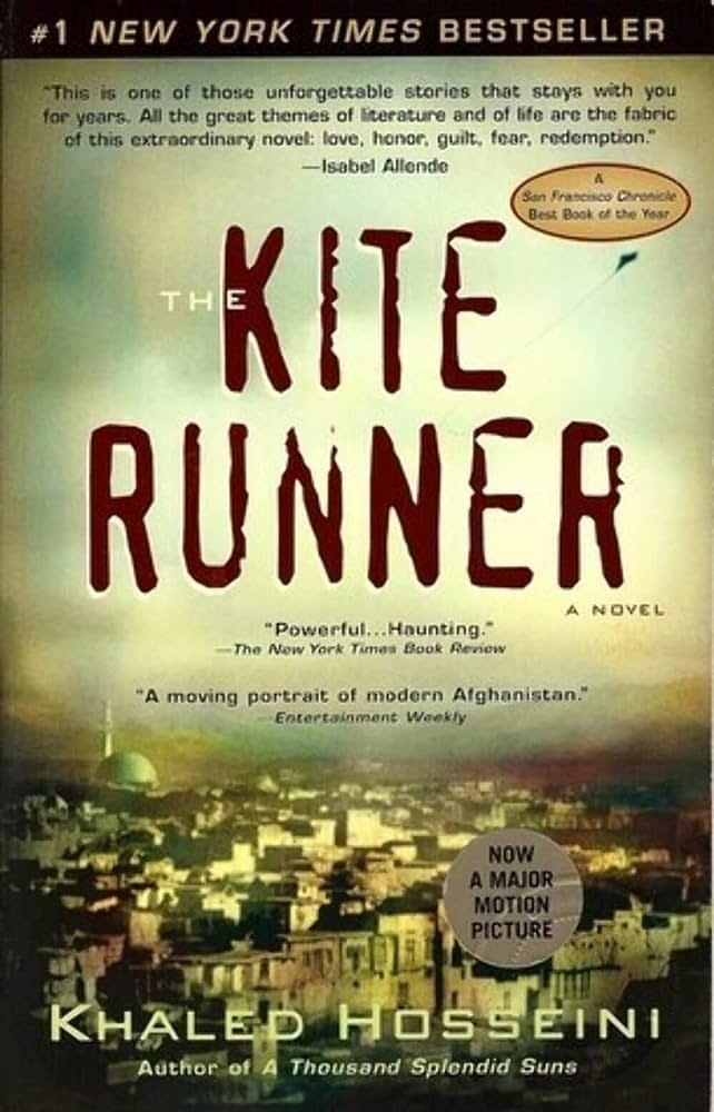 Book cover of "The Kite Runner" by Khaled Hosseini with accolades and a cityscape below the title