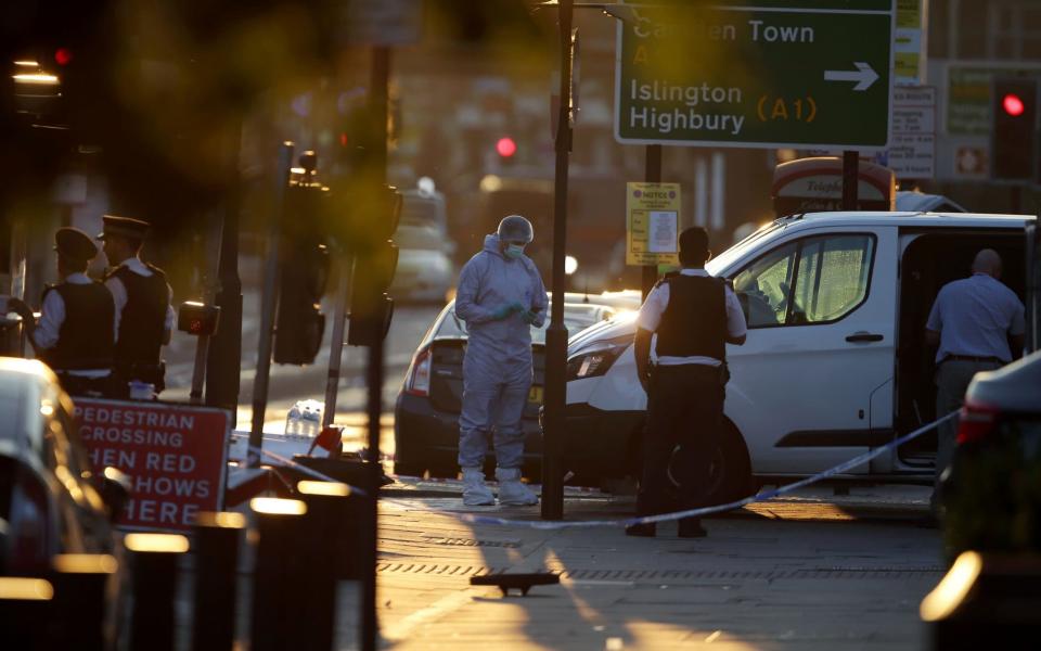 Forensic investigators work the scene in the Finsbury Park area of north London - Credit: AFP