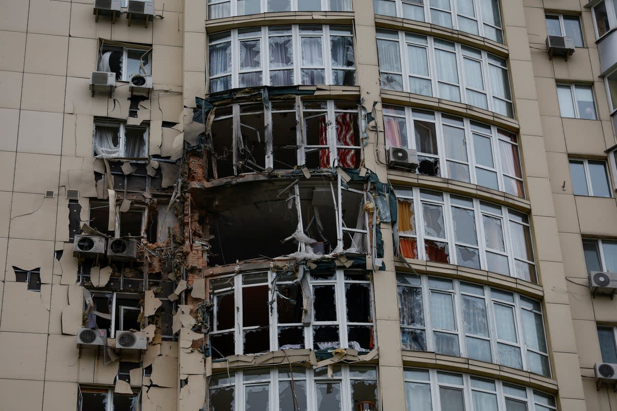 An apartment building was damaged by remains of a drone shot down during an overnight strike in Kyiv (REUTERS)