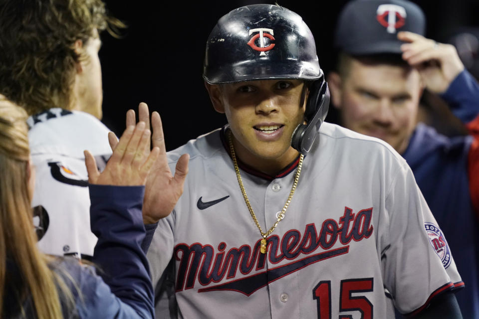 FILE - Minnesota Twins' Gio Urshela is greeted in the dugout after scoring during the fourth inning of a baseball game against the Detroit Tigers on Sept. 30, 2022, in Detroit. Ureshela went to salary arbitration with the Los Angeles Angels on Wednesday, Feb. 15, 2023, asking for $10 million rather than the team's $8.4 million offer. The 31-year-old hit .285 with 13 homers and 64 RBIs last season for Minnesota, which traded him to the Angels on Nov. 18 for minor league right-hander Alejandro Hidalgo. (AP Photo/Carlos Osorio, File)