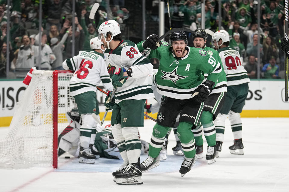 Dallas Stars center Tyler Seguin (91) celebrates next to Minnesota Wild center Frederick Gaudreau (89) after scoring in the first period of Game t of an NHL hockey Stanley Cup first-round playoff series Tuesday, April 25, 2023, in Dallas. (AP Photo/Tony Gutierrez)