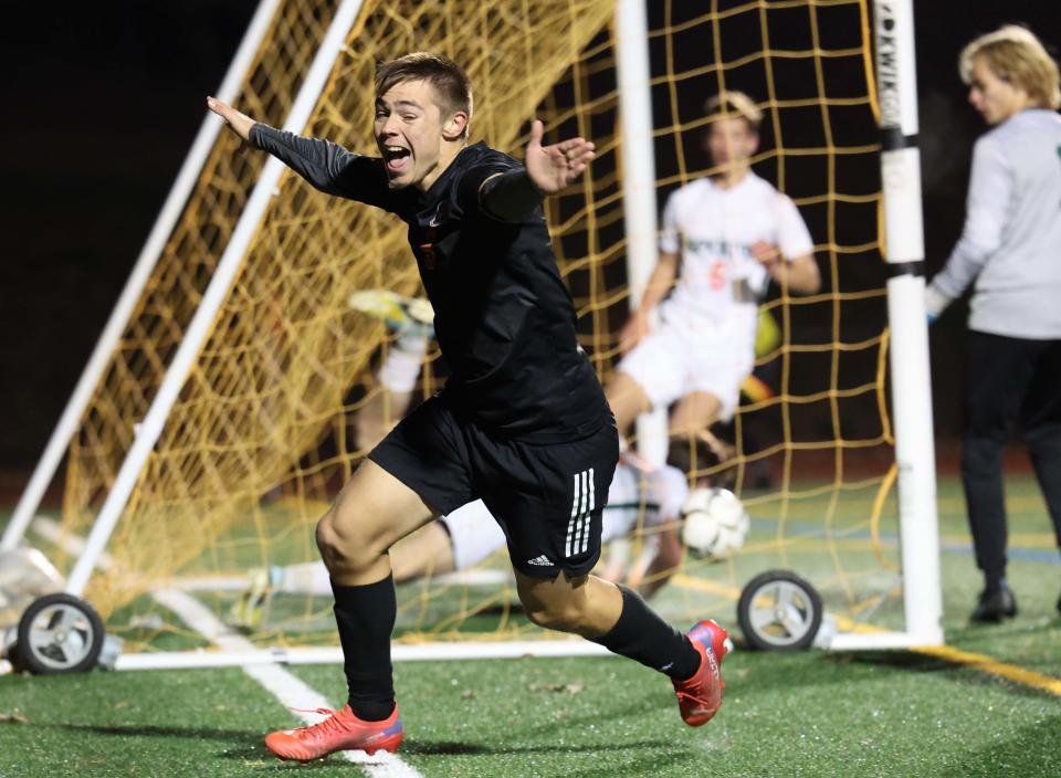 Oliver Ames' Hector Bucio scores a goal to tie the game at 2-2 past Hopkinton goalie Max Nye during the Division 2 state championship at Walpole High School on Saturday, Nov. 19, 2022.